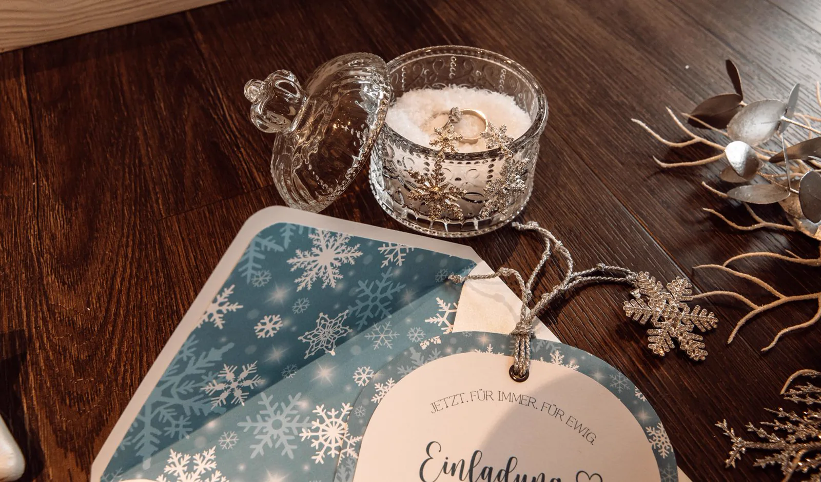 Winterliches Tafeldetail mit Kerze und Einladung